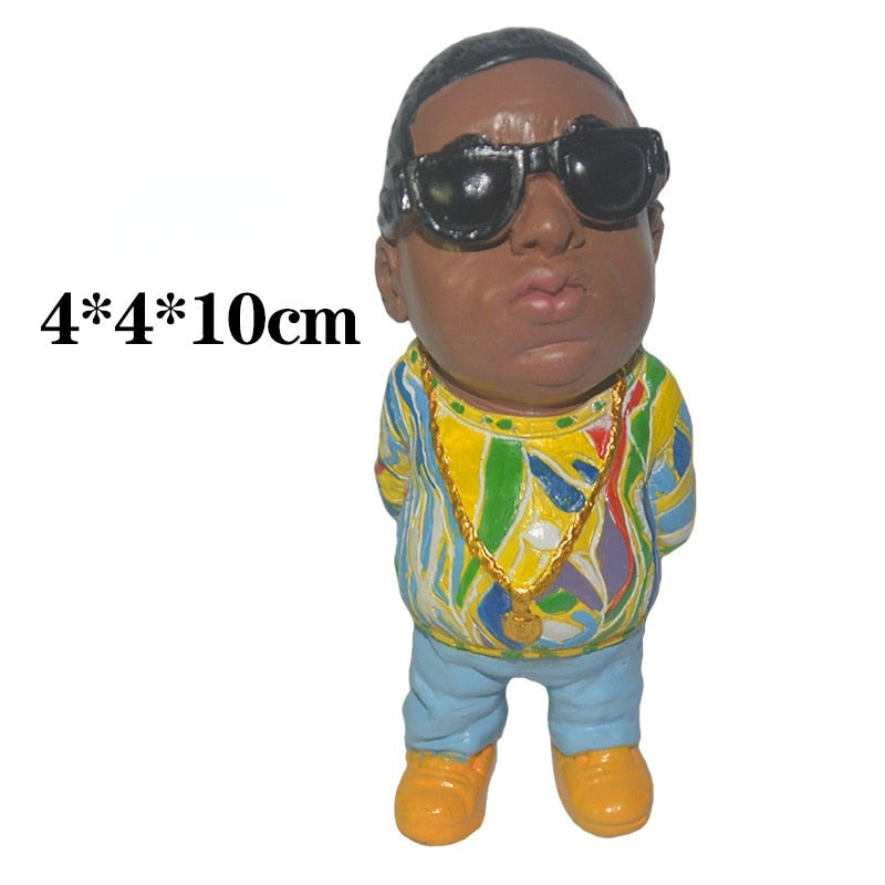 The Resin Art Mini Doll is a great addition to any home, office, car, or room decoration. Crafted from resin art and flavored with a hip hop rapper look, this unique kawaii accessory makes a bold, modern statement and is sure to draw attention. A perfect choice for those wanting to infuse artful styling into their decor, this mini doll is sure to spark conversation.